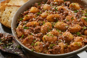 Plato de ñoquis caseros con salsa boloñesa tradicional