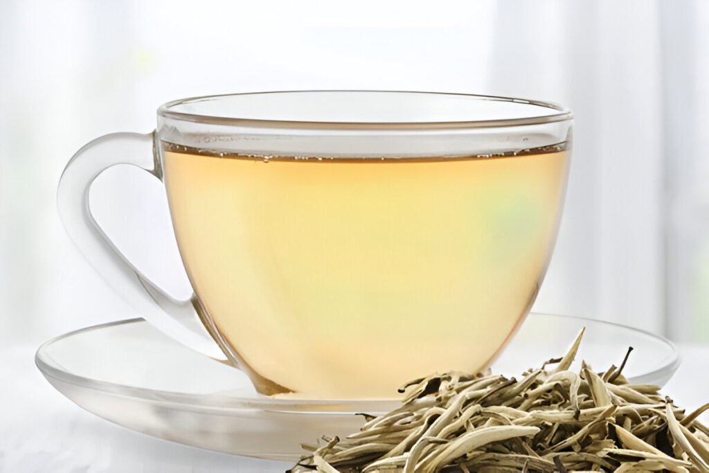 Taza de té blanco caliente con hojas infusionadas